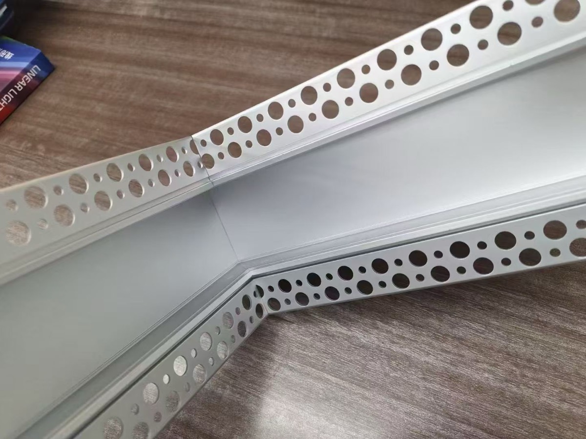 Custom angle-cut plaster-in LED aluminium profile with the diffuser cut to match, forming an obtuse bend