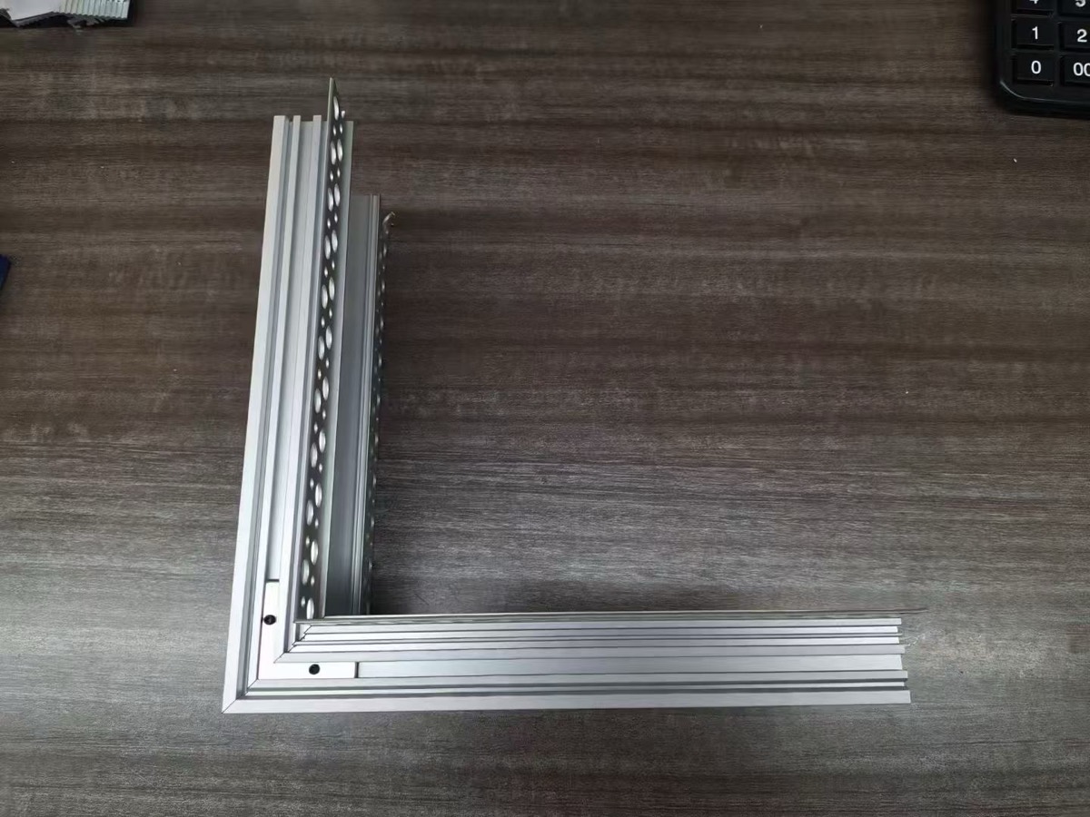 Custom 90-degree corner cut on a trimless plaster-in LED aluminium profile, two mitred sections joined into a right angle